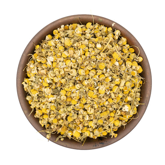 Organic dried chamomile flowers for tea in a bowl