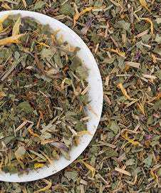 Gentle Detox Tea loose leaf herbal blend on a white plate